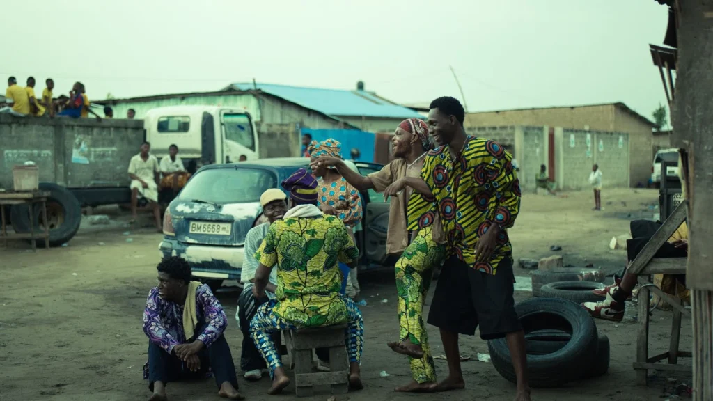 People in colourful traditional clothing on a lively urban street