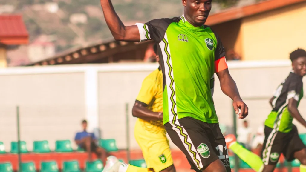 Football player in action during a match on a green field
